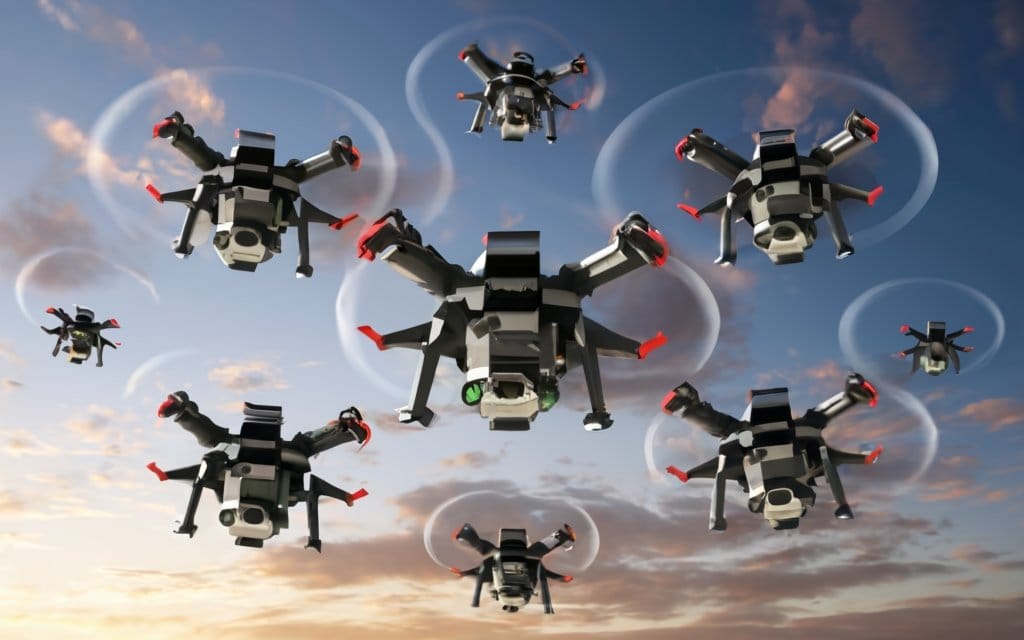 Nine mini drones flying in the sky, showcasing advanced drone technology and aerial capabilities.